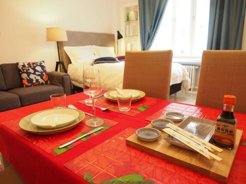 a table with plates and wine glasses on top of it at Top Apartments Helsinki - Alppila in Helsinki