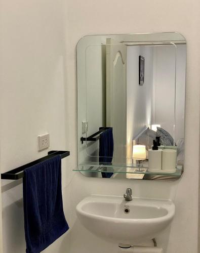 a bathroom with a sink and a mirror at homey stay and cafe by hematoa in Bangkok