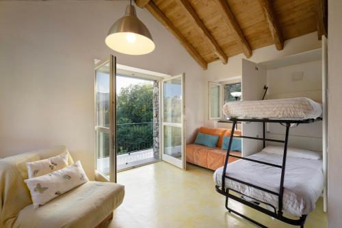 a room with two bunk beds and a couch at Il Mulino - Appartamento Terra in Borzonasca