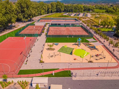 an aerial view of a tennis court with tennis courts at Hotel Helikon, Keszthely in Keszthely