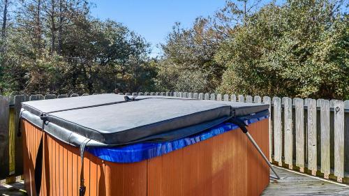 a hot tub sitting on a wooden deck next to a fence at Oceanside, 5 BRs, Wild Horses, 600 ft to Beach Access, 4wheel Drive Area, 4x2398, The T House in Knotts Island