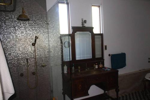 a bathroom with a shower and a sink and a mirror at Casa Cartagena en acantilado in Cartagena