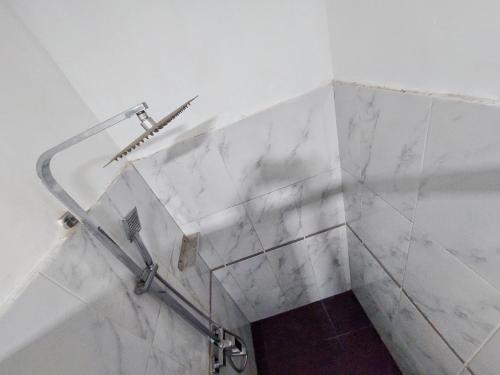 a bathroom with a shower with a glass wall at HOSTEL KATUNAYAKE At COLOMBO AIRPORT TRANSIT in Katunayake