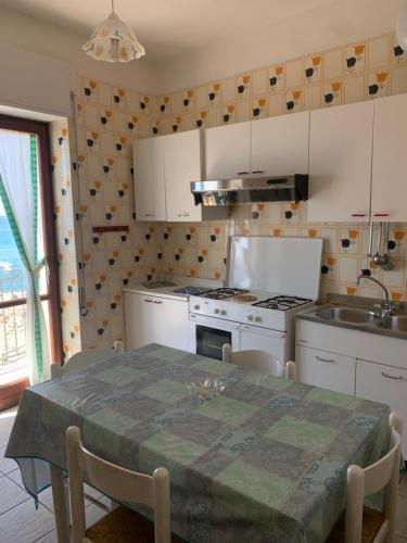 a kitchen with a table and a stove top oven at Marger Apartments in Santa Maria di Castellabate