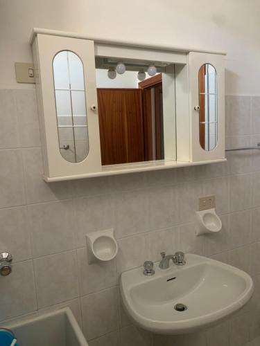 a bathroom with a sink and a mirror at Marger Apartments in Santa Maria di Castellabate