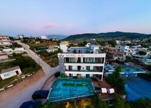 a hotel with a swimming pool in a city at Ilio Boutique Hotel in Ksamil
