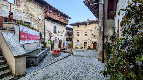 an alley in an old town with buildings at B&B Piccolo Tibet in Lavenone