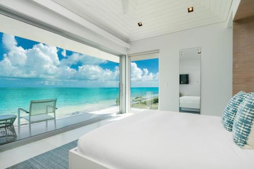 a bedroom with a view of the ocean at Long Bay Beach Club in Long Bay Hills