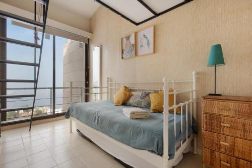 a bedroom with a bed and a large window at Vista Bella in Santa Úrsula