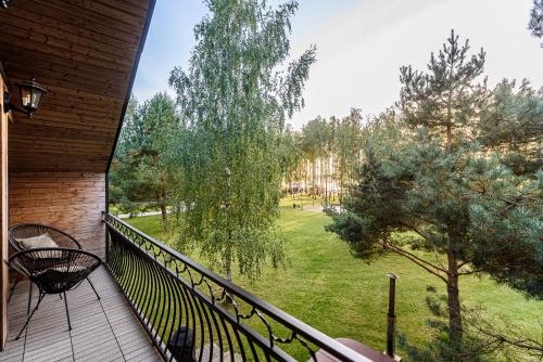a balcony with a view of a park at Pirties Spa namas in Molėtai