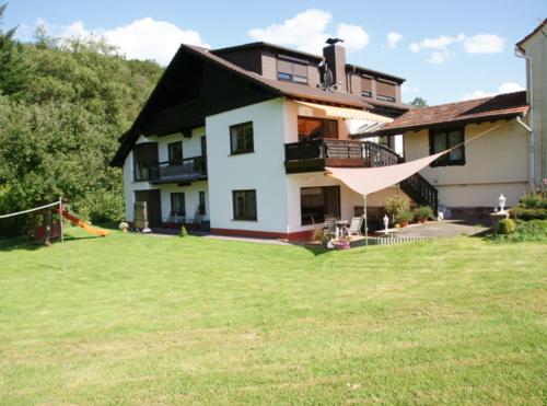 a house with a large lawn in front of it at Ferienwohnung Siefert in Mossautal