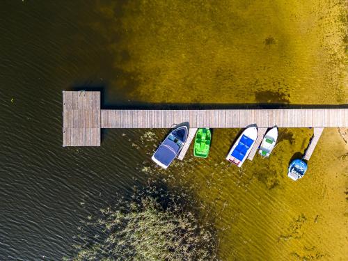 a group of boats parked next to a dock at Pirties Spa namas in Molėtai