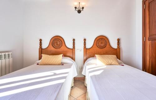 two beds sitting next to each other in a room at Quiet Villa in Buger with amazing pool, paddle court and nice garden in Búger