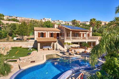 an aerial view of a house with a swimming pool at Quiet Villa in Buger with amazing pool, paddle court and nice garden in Búger