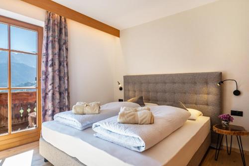 a bedroom with a bed with two pillows on it at Häuslerhof App Pinus in Villabassa
