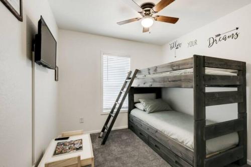 a bedroom with a bunk bed and a ceiling fan at Cozy Mountain Town Farmhouse with Air Conditioning in Mountainaire