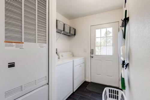 a kitchen with a white refrigerator and a window at Cozy Mountain Town Farmhouse with Air Conditioning in Mountainaire