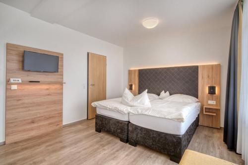 Ένα ή περισσότερα κρεβάτια σε δωμάτιο στο Hotel Wiehen-Therme