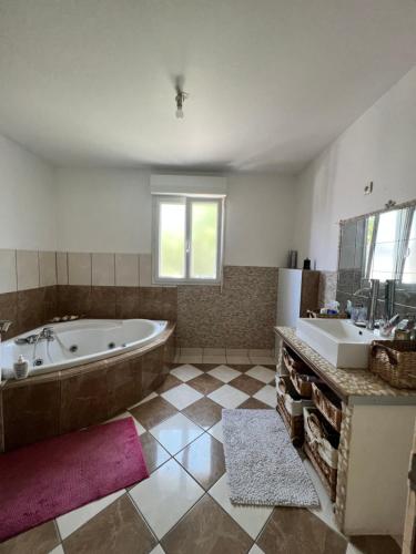 ein großes Bad mit einer Badewanne und 2 Waschbecken in der Unterkunft Maison de vacances in Chambray-lès-Tours