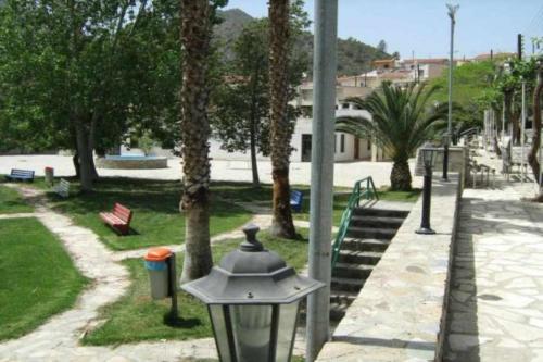 a street light next to a park with palm trees at Beautiful 3 Bedr House in Arakapas with fireplace in Arakapas