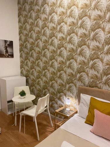 a living room with a bed and a table and chairs at DOMUS LUIGI LEONE 2 in Naples