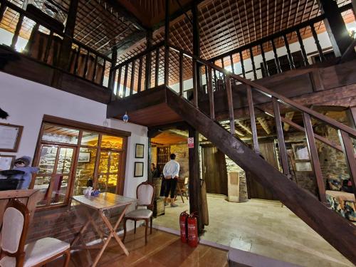 a room with a wooden staircase in a house at Helvacılar Konağı in Karacasu