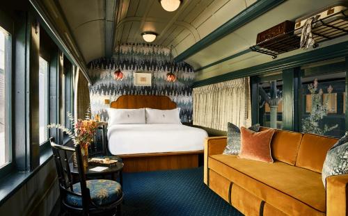 a train room with a bed and a couch at The Hotel Chalet at The Choo Choo in Chattanooga