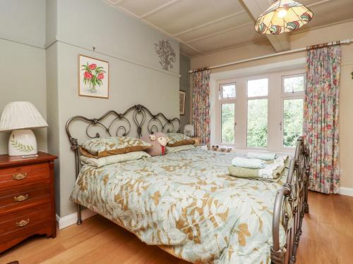 a bedroom with a large bed and a window at Oak Cottage in Skipton