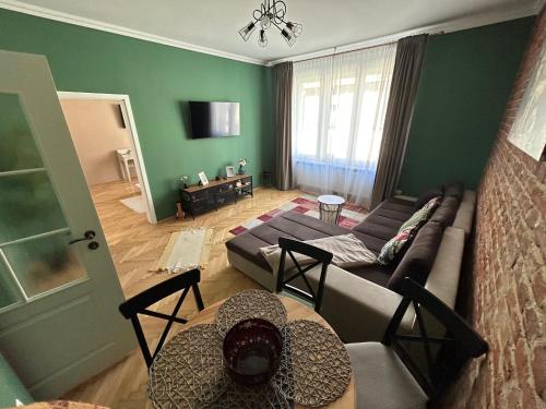 a living room with a couch and a table at Asha Central Apartment in Timişoara