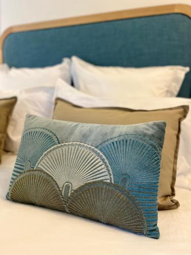 a pillow sitting on top of a bed at Richard Lequet Domaine gastronomique du Val d Atur in Boulazac