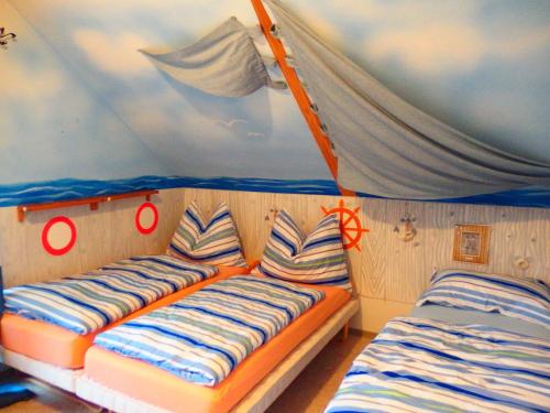 a room with two beds in a tent at Vila Familyparadise Bergstrasse in Sankt Michael im Lungau