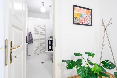 a bathroom with a toilet and a plant at Jupiter Home Buda in Budapest