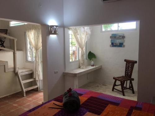 a bedroom with a bed and a chair and a window at Cabrera Chalet boutique hotel in Cabrera