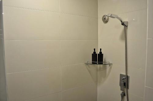 a shower with two bottles on a shelf in a bathroom at Royal Suites At Dua Sentral in Kuala Lumpur