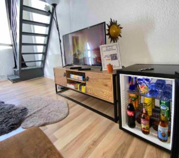 un soggiorno con frigorifero e TV di Cocon à Deux Pas des Arènes - Charme & Confort a Nîmes