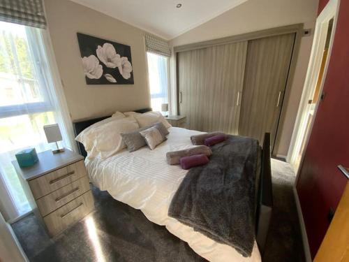 a bedroom with a bed with pillows on it at Country Gem in Tydd Saint Giles