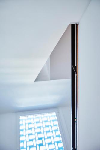 a glass window with a light shining through it at Hôtel California in Le Lavandou