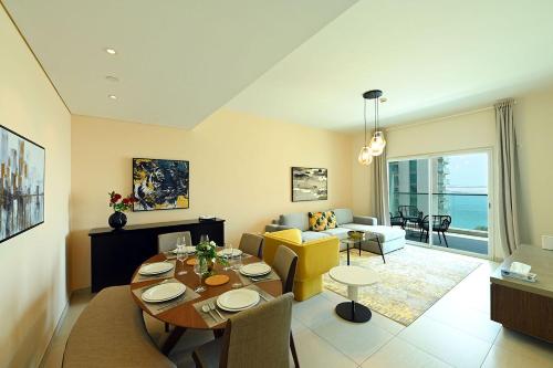 a living room with a table and a dining room at EliteRetreat - SeaView - Gym & Pool Access - Reem Island in Abu Dhabi