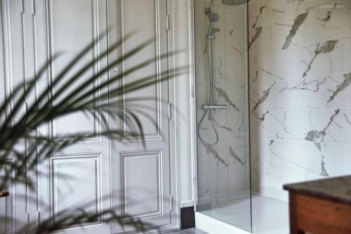 a bathroom with a shower and a glass door at Château Le Repos - Luxury air-conditioned property with pool in Rouffignac-de-Sigoulès