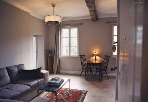 a living room with a couch and a table at Château Le Repos - Luxury air-conditioned property with pool in Rouffignac-de-Sigoulès