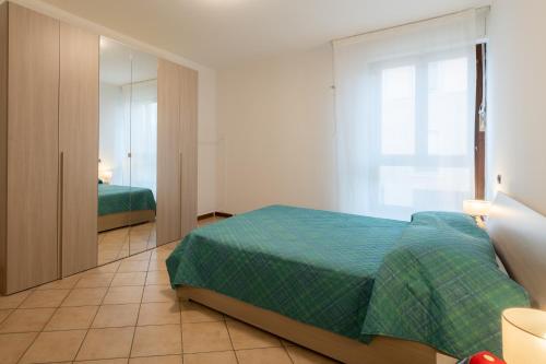 um quarto com uma cama verde e um espelho em Mizar*Q-Ampio Quadrilocale ad uso privato em Foligno