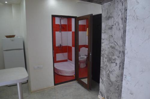 a bathroom with a toilet in a room at Irakli's Apartment with Sea view in Batumi