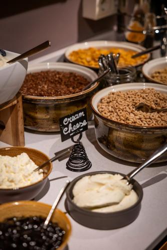 a table filled with different types of food in bowls at Reykjavik Marina - Berjaya Iceland Hotels in Reykjavík