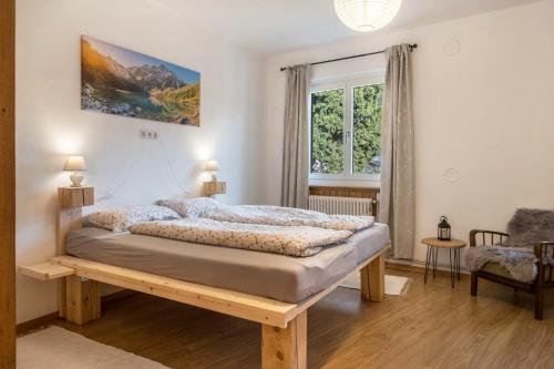 a bedroom with a bed in a room with a window at Ferienhaus Weingut Plonerhof in Bolzano