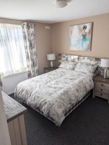 a bedroom with a bed and a painting on the wall at Red Deer Village Holiday Park - 3 Bedroom, Self-Catering Holiday Home in Steps