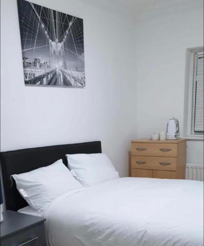 a bedroom with a bed and a ferris wheel at Modern Stylish Two Bedroom Apartment in Beckenham