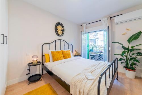 a bedroom with a large bed with yellow pillows at JetSet by Edsam in Madrid