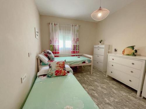 a small bedroom with a bed and a dresser at Casa Mary R&R in Albolodúy