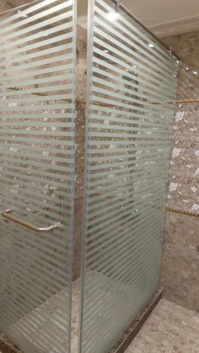 a glass shower door in a bathroom with at شقه فندقيه المهندسين in Cairo