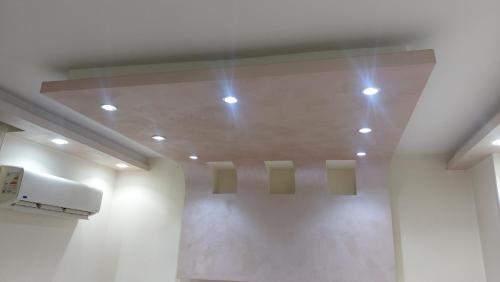 a room with lights on the ceiling in a building at شقه فندقيه المهندسين in Cairo